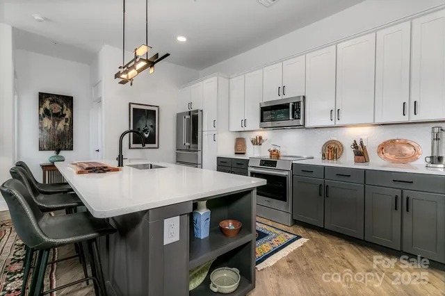 a kitchen with sink stove and cabinets