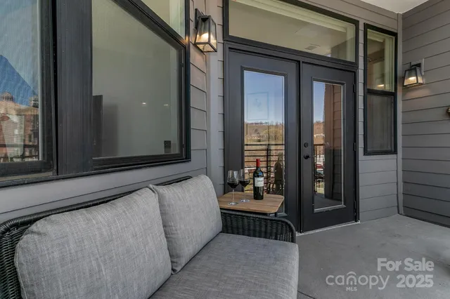 a backyard of a building with barbeque oven table and chairs