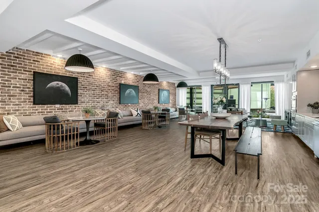a living room with furniture a fireplace and a dining table with wooden floor