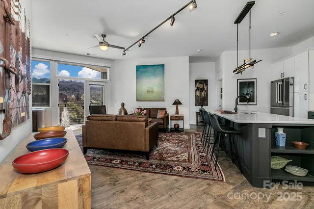 a living room with furniture a dining table and chairs