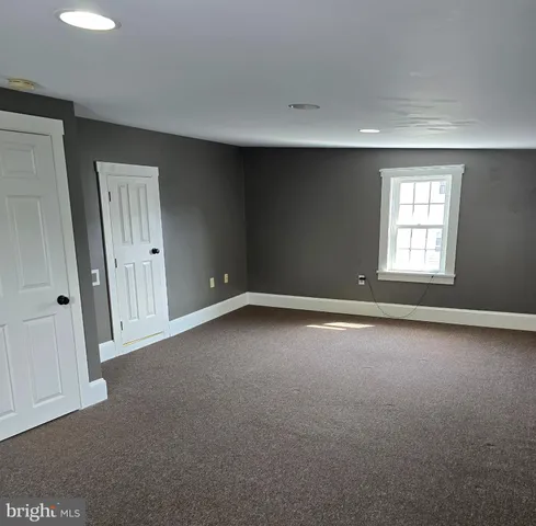 an empty room with a empty space and windows
