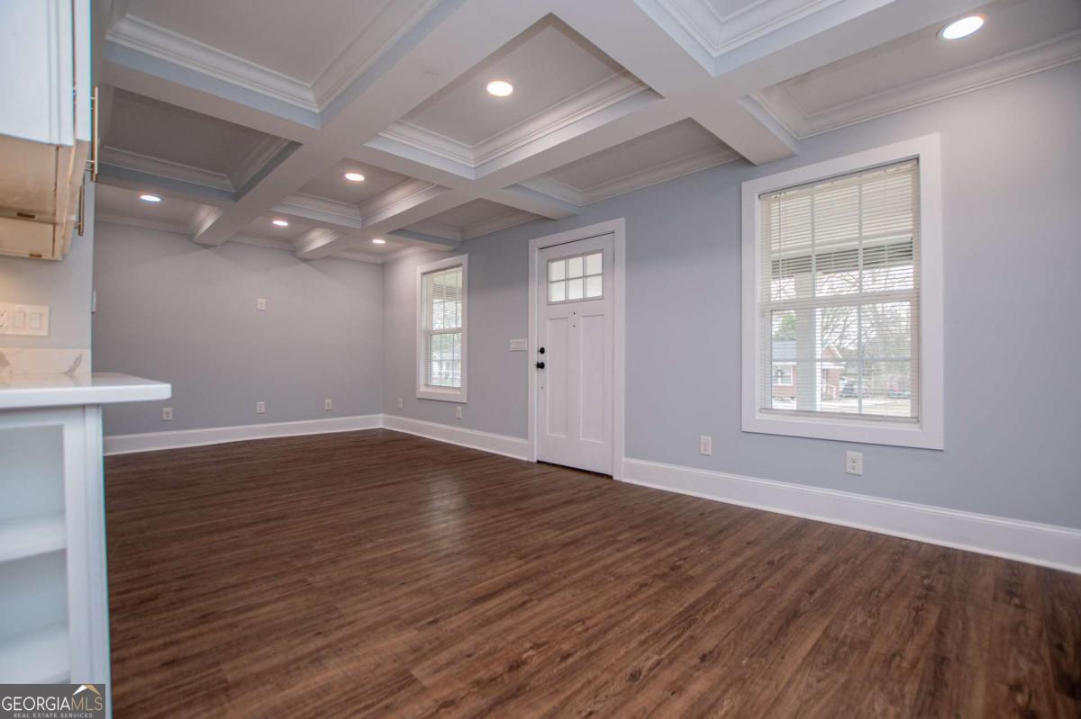 106 Mara Street Carrollton, GA 30117 - Photo 12 of 52 a view of an empty room with wooden floor and a window