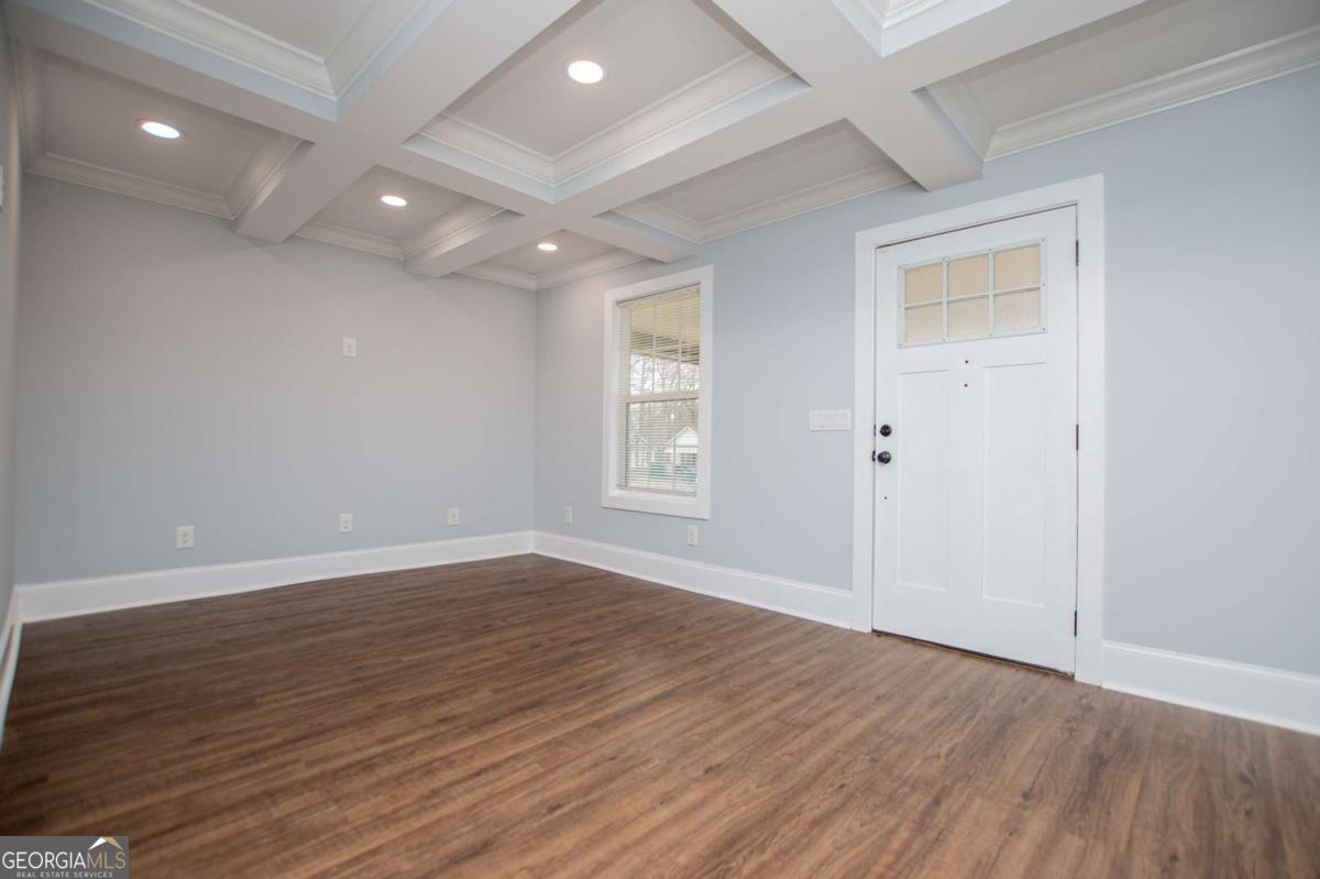 106 Mara Street Carrollton, GA 30117 - Photo 16 of 52 an empty room with wooden floor and windows