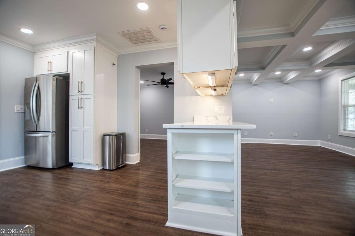 106 Mara Street Carrollton, GA 30117 - Photo 19 of 52 a kitchen with stainless steel appliances a refrigerator and wooden floor