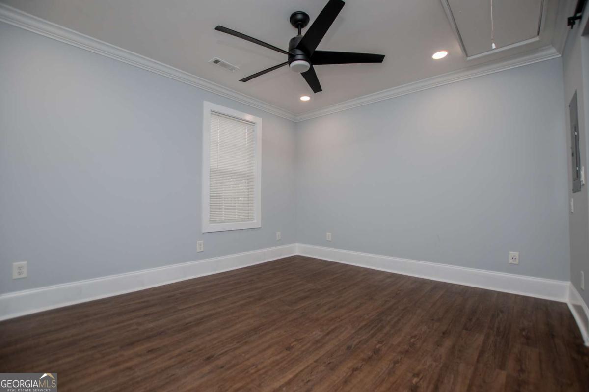 106 Mara Street Carrollton, GA 30117 - Photo 31 of 52 a view of a room with wooden floor and a ceiling fan