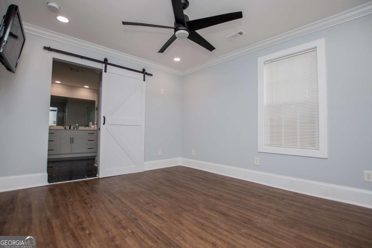 106 Mara Street Carrollton, GA 30117 - Photo 33 of 52 a view of empty room with wooden floor and fan