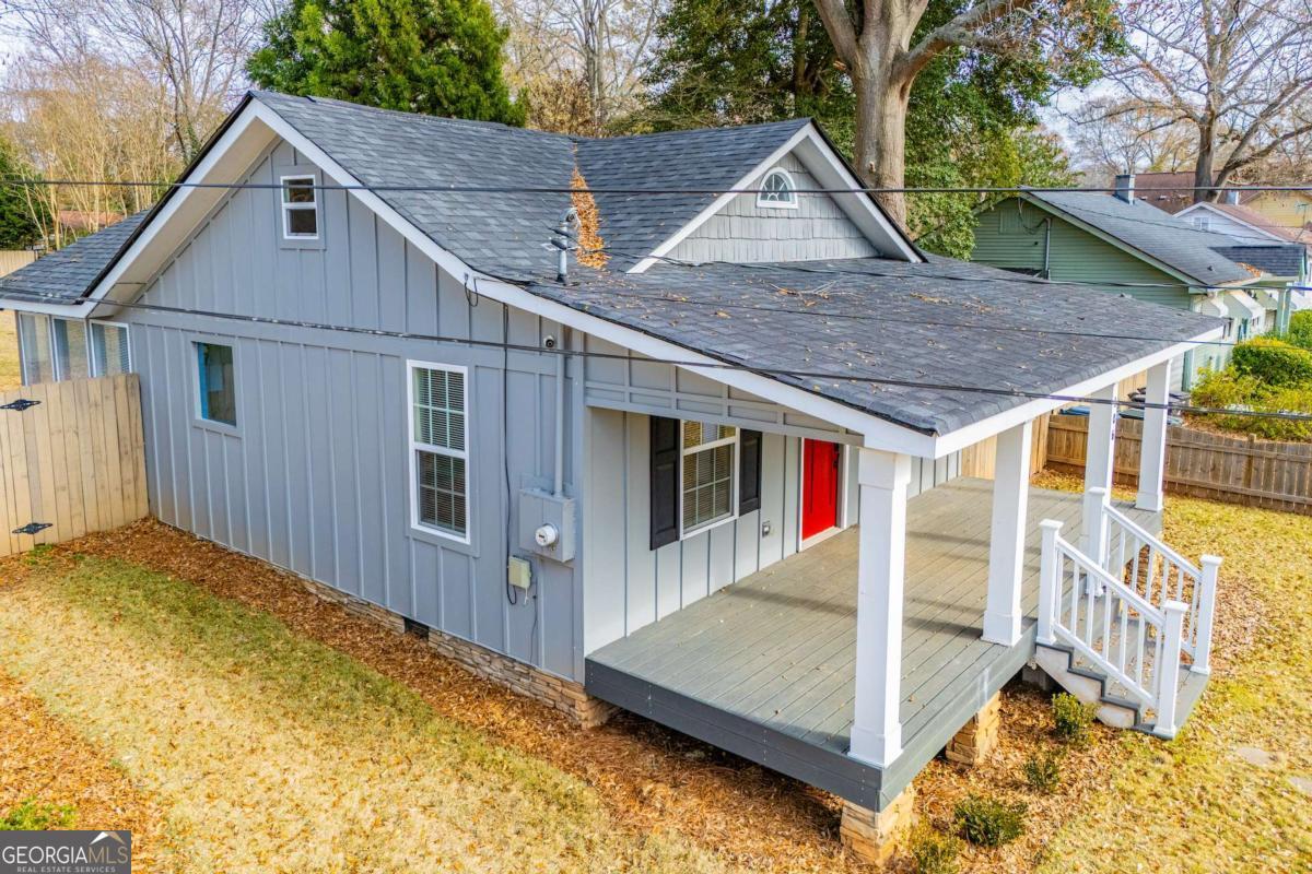 106 Mara Street Carrollton, GA 30117 - Photo 48 of 52 a view of a house with a small yard and wooden fence