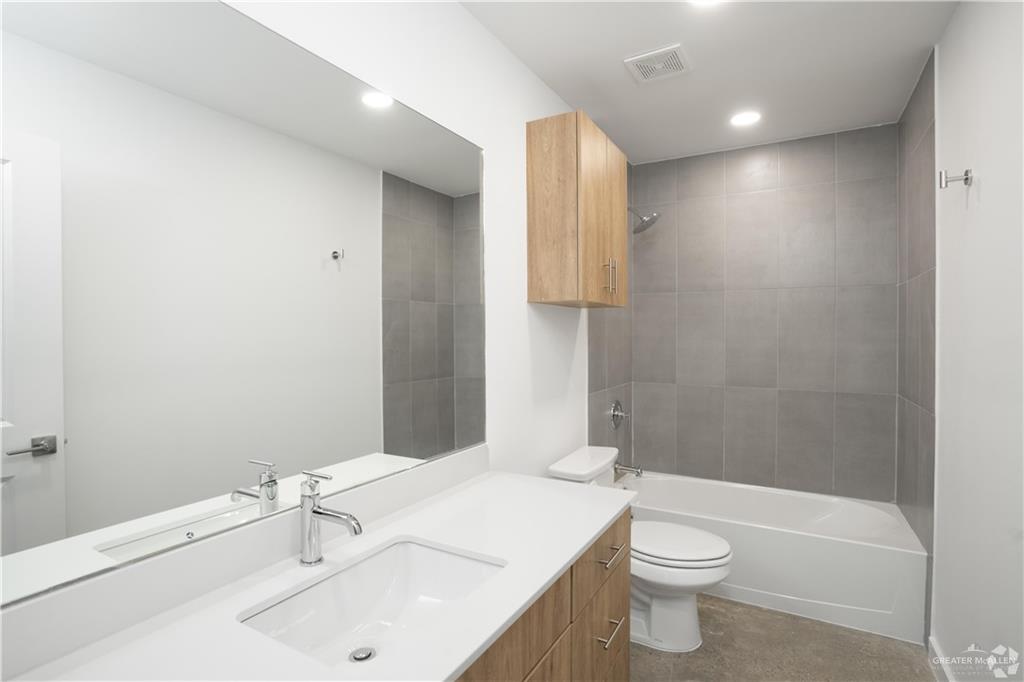 4013 Jenna Lane, Unit D Weslaco, TX 78599 - Photo 11 of 24 a bathroom with a sink toilet and shower