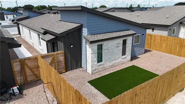 a aerial view of a house with roof deck front of house
