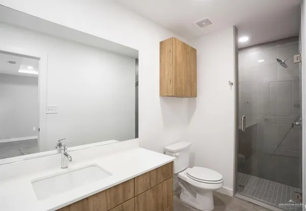a bathroom with a sink toilet and shower