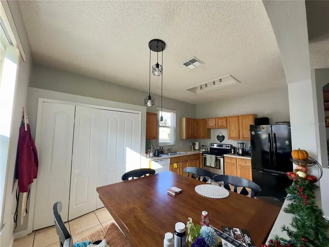 a kitchen with a table chairs and appliances