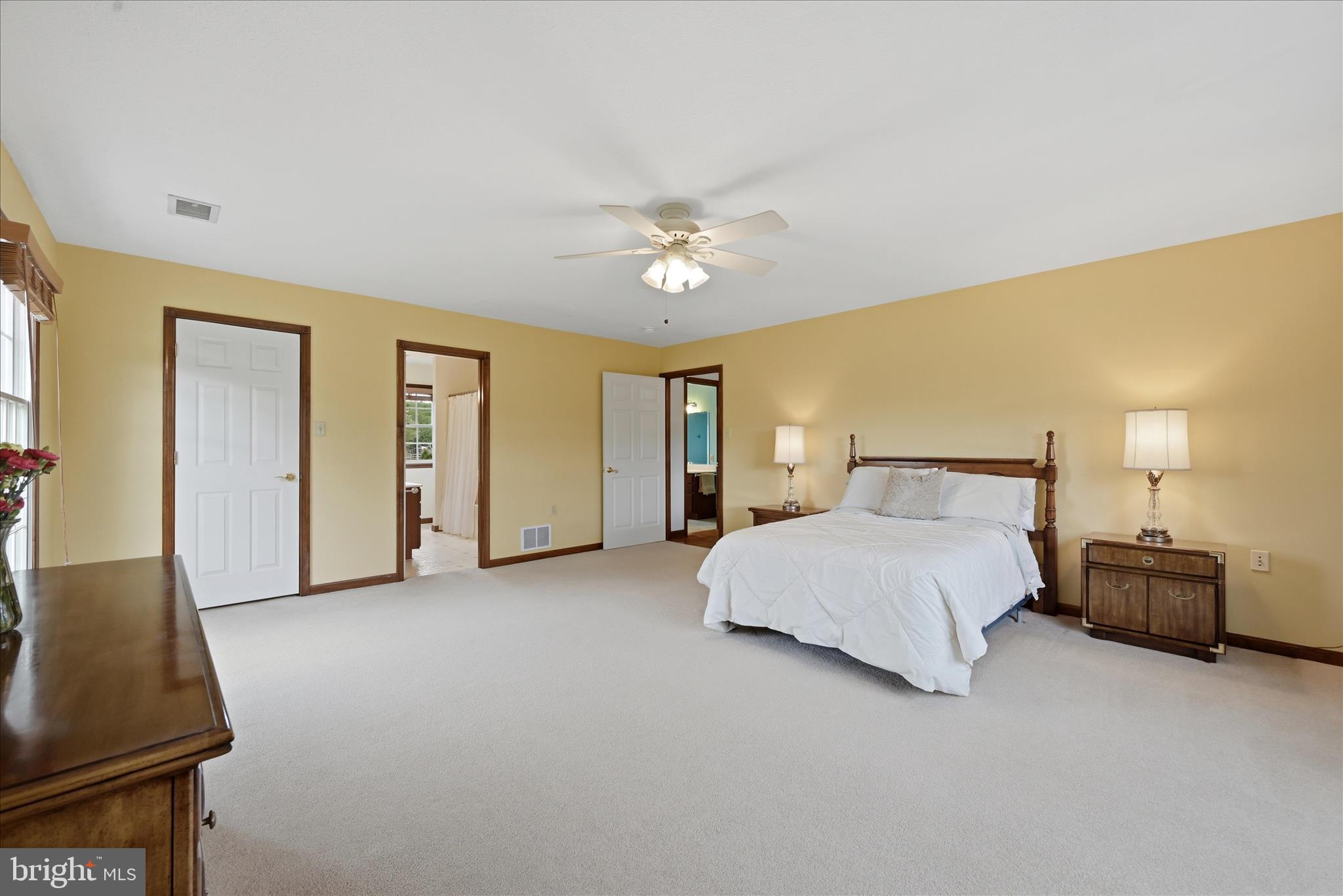412 Ruebuck Road Clear Brook, VA 22624 - Photo 21 of 43 a spacious bedroom with a bed and a lamp