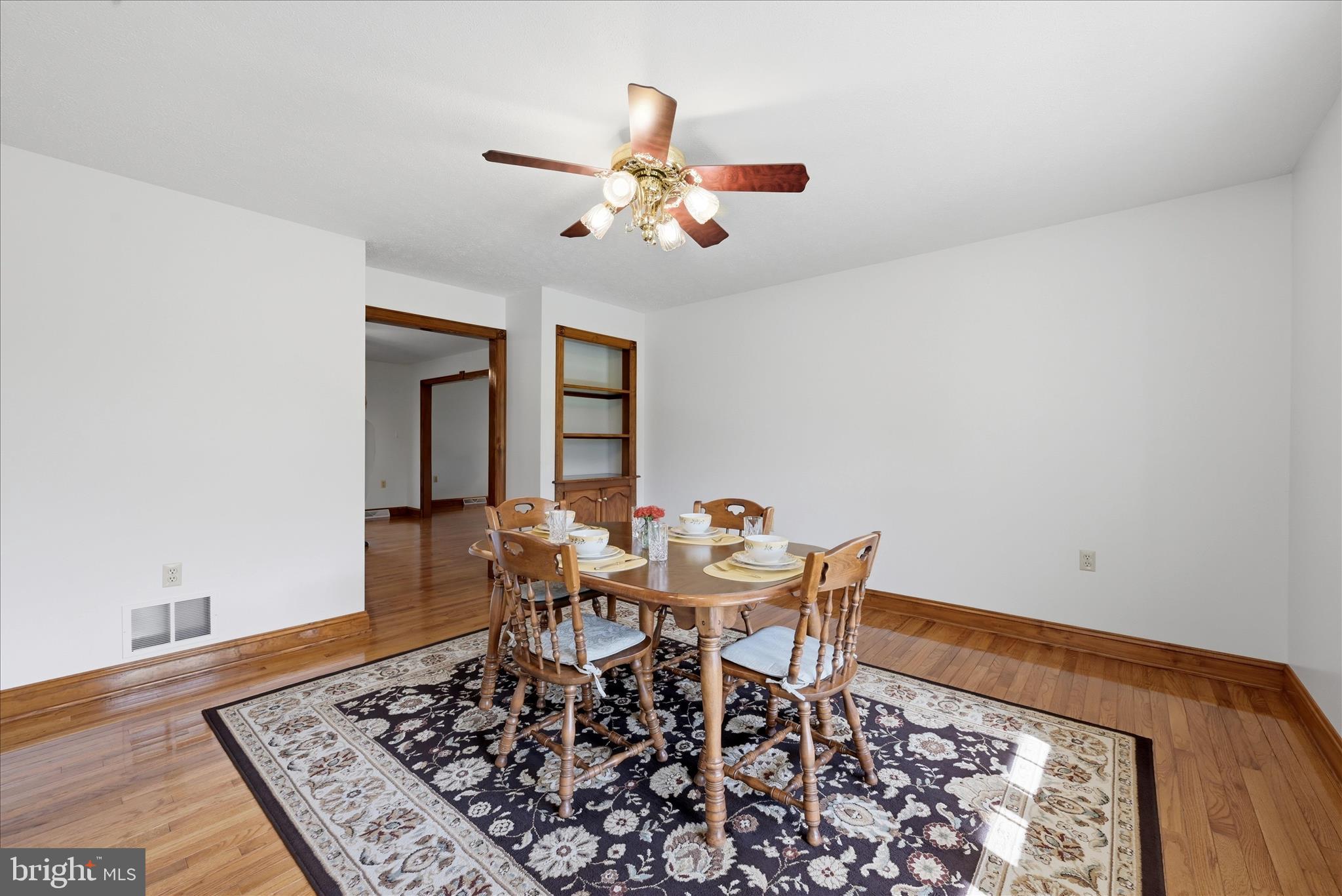 412 Ruebuck Road Clear Brook, VA 22624 - Photo 6 of 43 a dining room with wooden floor and a rug