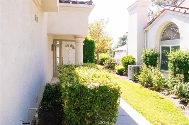 a view of a house with a small yard and plants