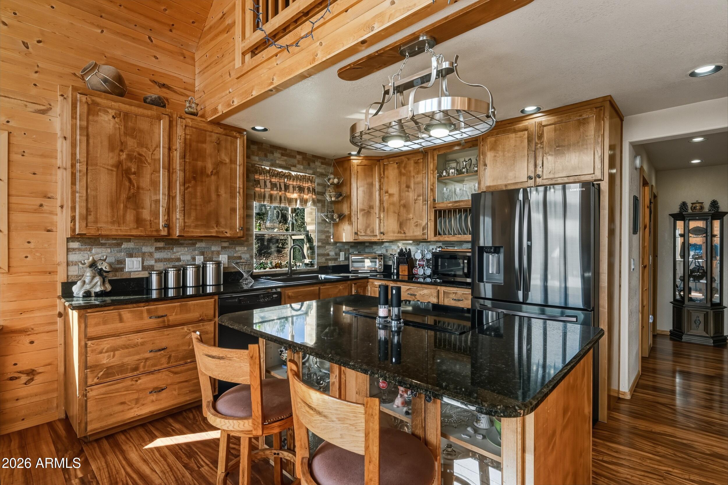 3119 Kysar Way Pine, AZ 85544 - Photo 14 of 68 a kitchen with granite countertop stainless steel appliances a refrigerator a stove top oven and cabinets
