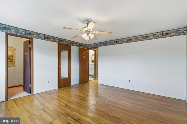 a view of an empty room with wooden floor