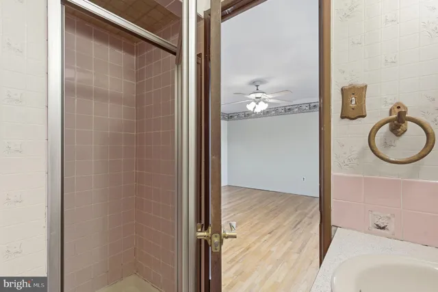 a bathroom with a granite countertop shower