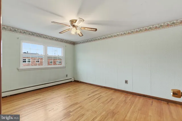 a view of a room with wooden floor and windows