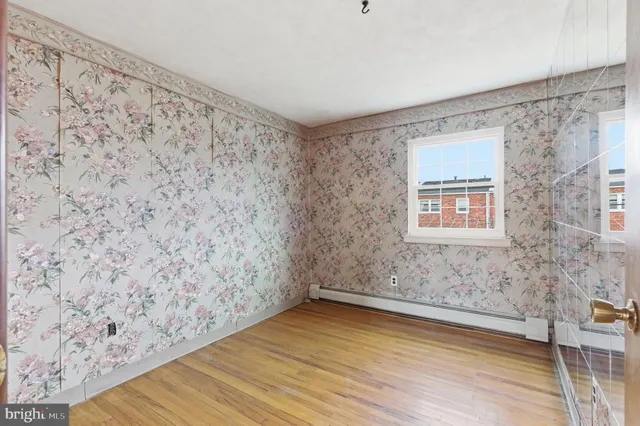 a view of a room with wooden floor and brick wall