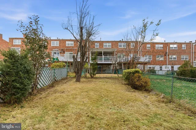 a view of a house with backyard and patio