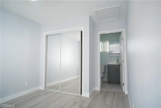 an empty room with closet and a bathroom