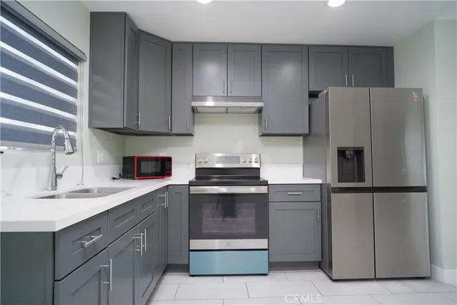 a kitchen with a stove sink and refrigerator
