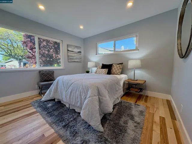 a bed sitting in a bedroom next to a window