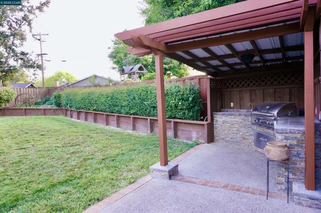 a backyard of a house with table and chairs