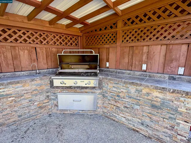 a kitchen with granite countertop a stove and a microwave