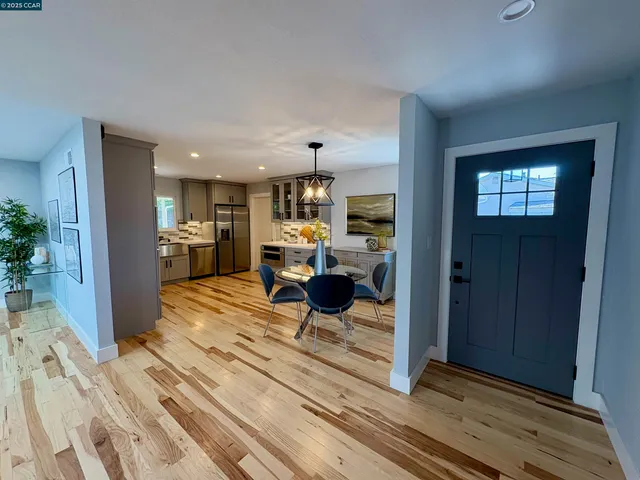 a living room with furniture a couch and potted plants
