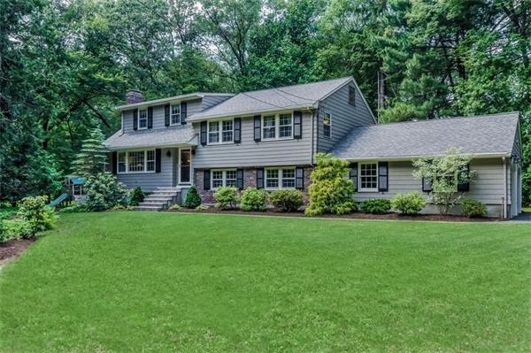 62 Moore Road Wayland, MA 01778 - Photo 1 of 22 a front view of a house with a yard table and chairs
