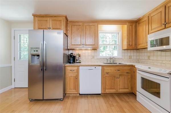 62 Moore Road Wayland, MA 01778 - Photo 7 of 22 a kitchen with stainless steel appliances a refrigerator sink and microwave