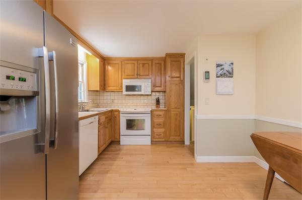 62 Moore Road Wayland, MA 01778 - Photo 8 of 22 a kitchen with a refrigerator and a stove top oven