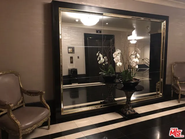 a living room with furniture and a lamp