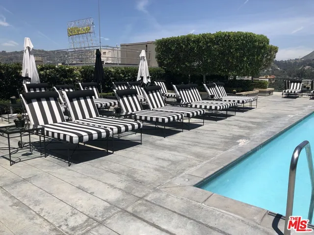 a view of staircase with a large window and wooden floor
