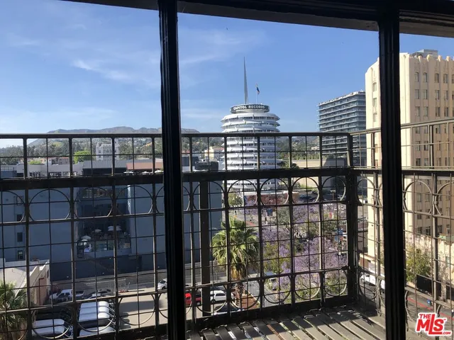 a view of a refrigerator in kitchen and an empty room