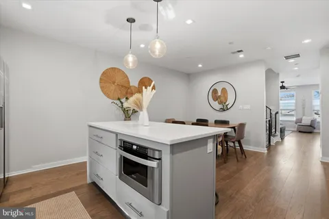 a kitchen with a dining table chairs sink and cabinets