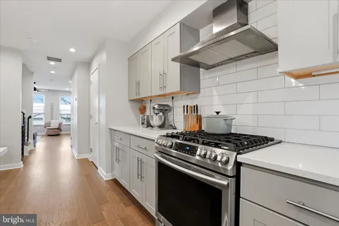 a kitchen with a dining table chairs and white cabinets