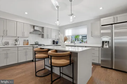 a kitchen with stainless steel appliances granite countertop a sink stove and cabinets
