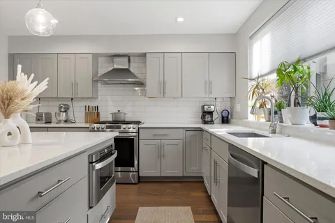 a kitchen with appliances cabinets and a sink