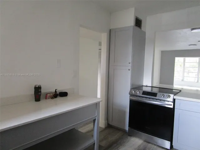 a kitchen with a stove and a sink