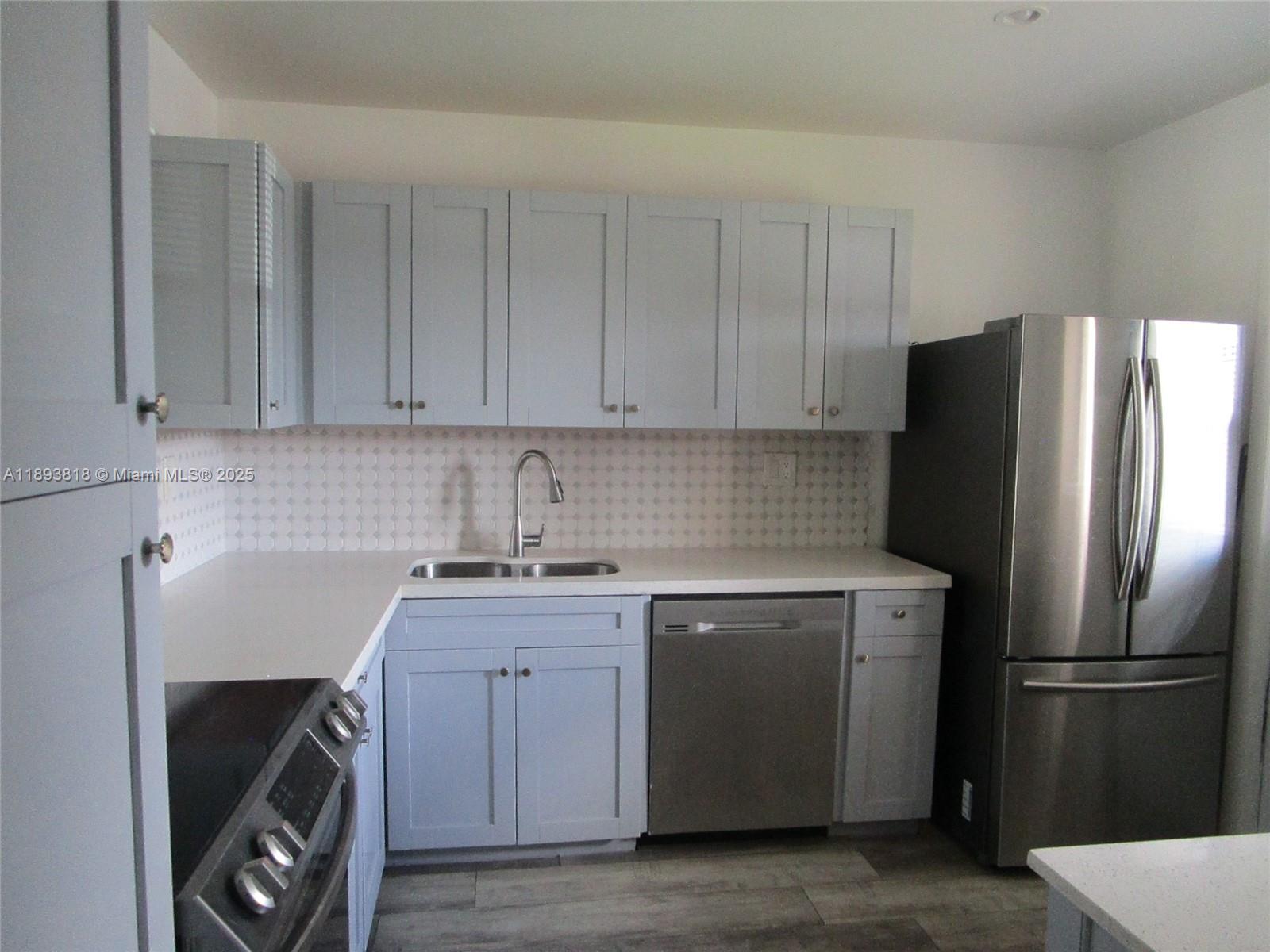 8101 Southwest 24th Court, Unit 206 Davie, FL 33324 - Photo 13 of 41 a kitchen with a refrigerator sink and cabinets