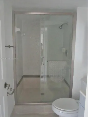 a bathroom with a shower and a toilet