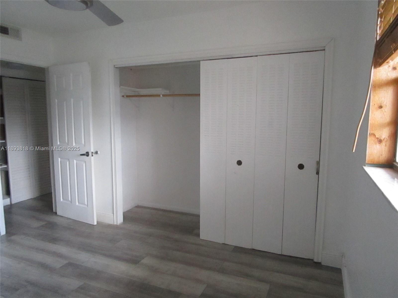 8101 Southwest 24th Court, Unit 206 Davie, FL 33324 - Photo 23 of 41 a view of an empty room with wooden floor and a window
