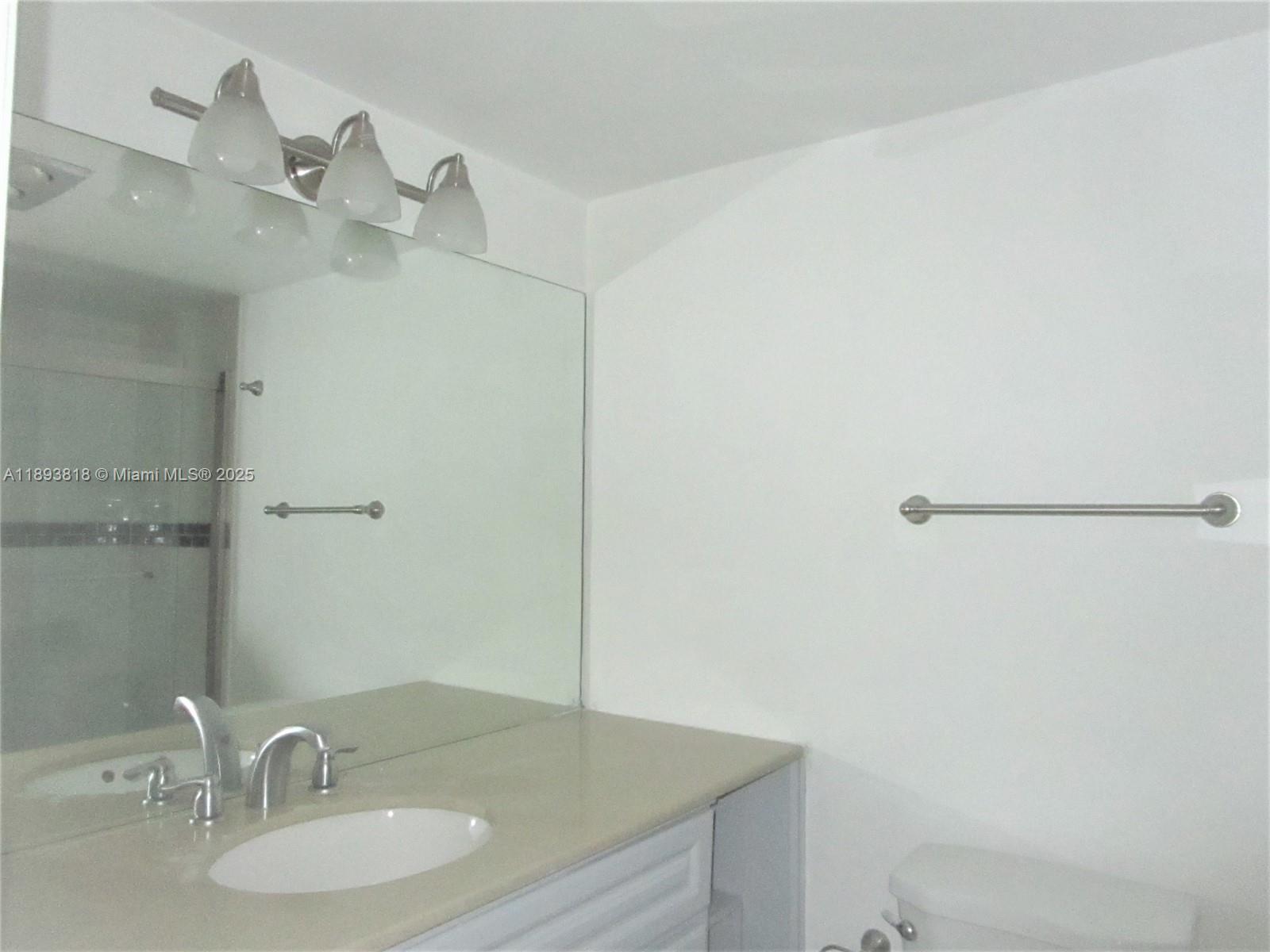 8101 Southwest 24th Court, Unit 206 Davie, FL 33324 - Photo 30 of 41 a bathroom with a sink and a mirror