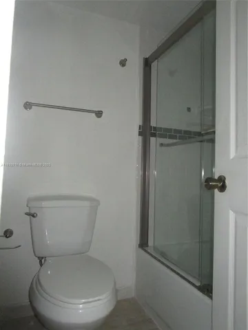 a white toilet sitting next to a bathroom sink