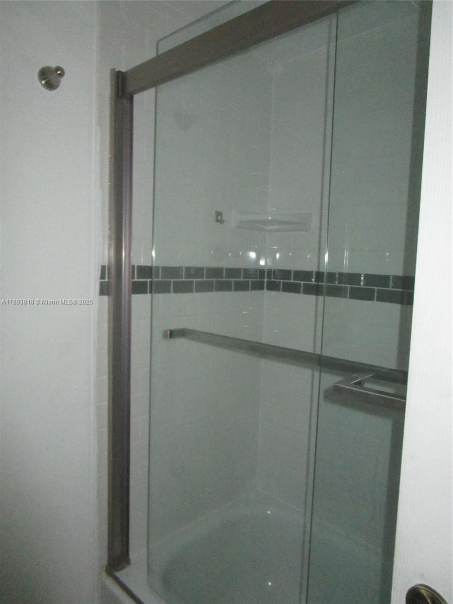 8101 Southwest 24th Court, Unit 206 Davie, FL 33324 - Photo 33 of 41 a bathroom with a glass shower door