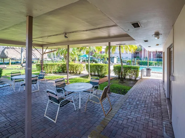 a view of a porch with chairs and backyard