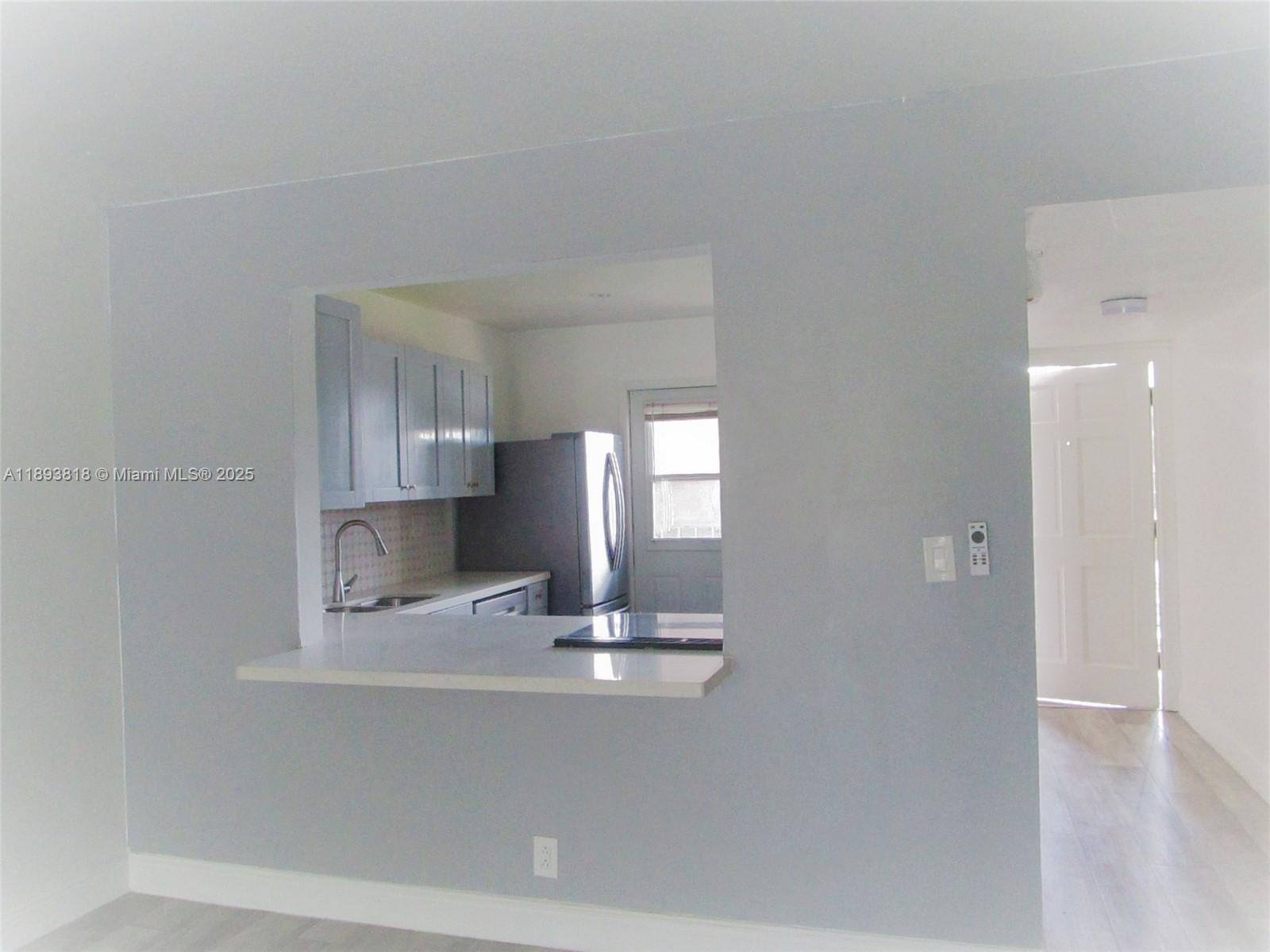 8101 Southwest 24th Court, Unit 206 Davie, FL 33324 - Photo 9 of 41 a kitchen with a refrigerator and window