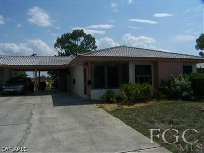 1602 Ridgecrest Street Lehigh Acres, FL 33936 - Photo 1 of 12 a front view of house with yard